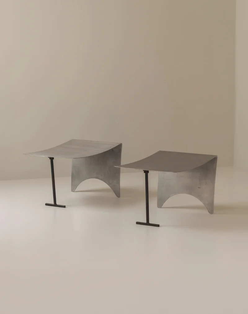A striking set Modernist curved metal stools from France, dating to the 1980s.