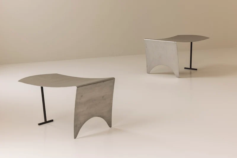 A striking set Modernist curved metal stools from France, dating to the 1980s.