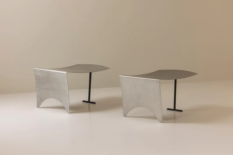 A striking set Modernist curved metal stools from France, dating to the 1980s.