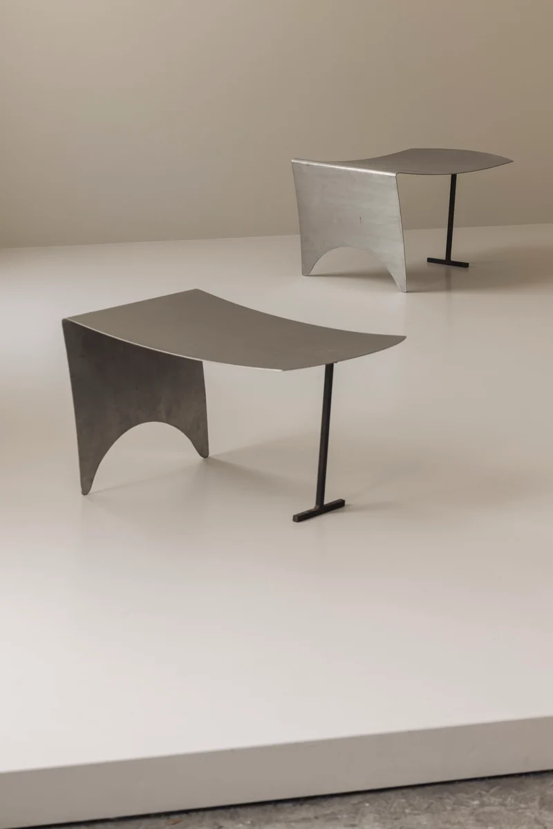 A striking set Modernist curved metal stools from France, dating to the 1980s.