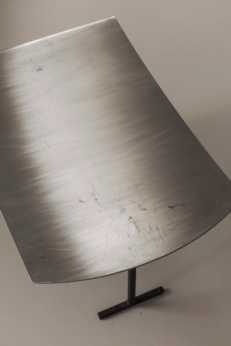 A striking set Modernist curved metal stools from France, dating to the 1980s.