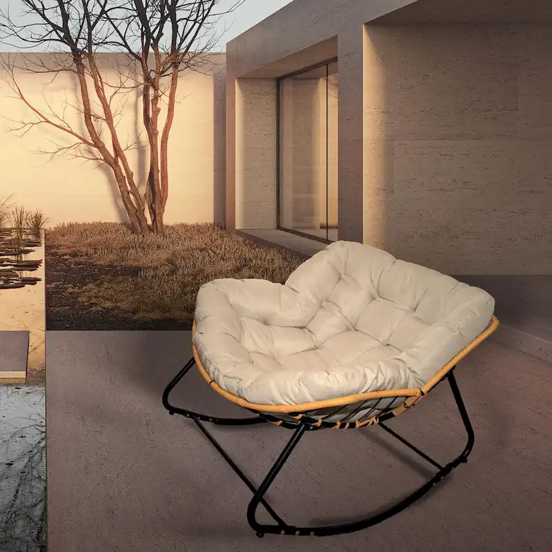 Fauteuil à bascule en rotin tressé gris foncé avec coussins et structure en métal