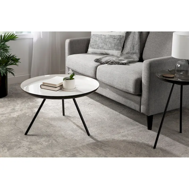 Table basse ronde en métal avec pieds trépied et finition émail bicolore blanc et noir