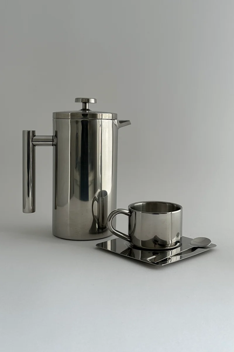 'HEDONISM' stainless steel cup with saucer