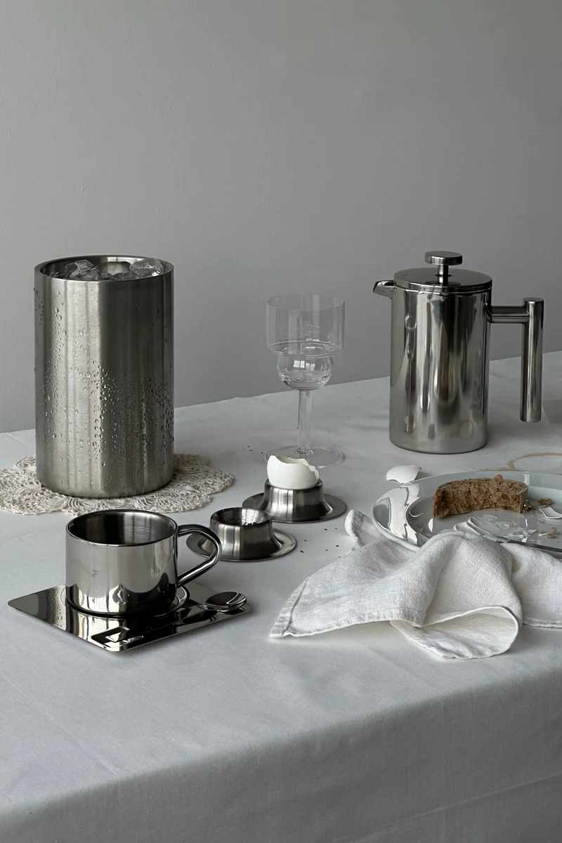 'HEDONISM' stainless steel cup with saucer